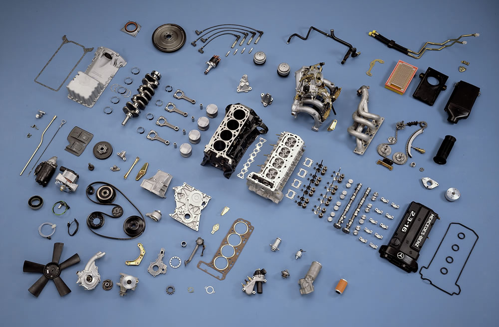 Every component of a Mercedes-Benz 2.3-16 engine laid out piece by piece